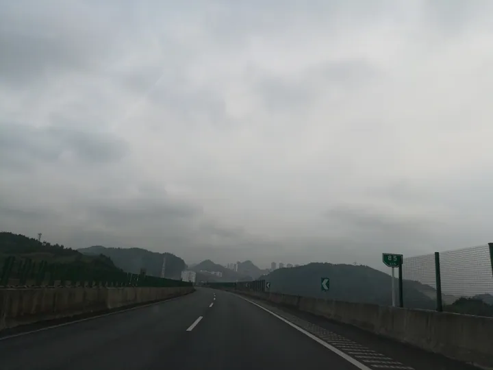 Elevated road curving toward the hazy skyline of Tongren, Guizhou