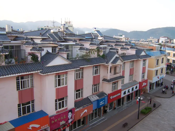 Street lined with traditional tile-roofed shopfronts in Yimen