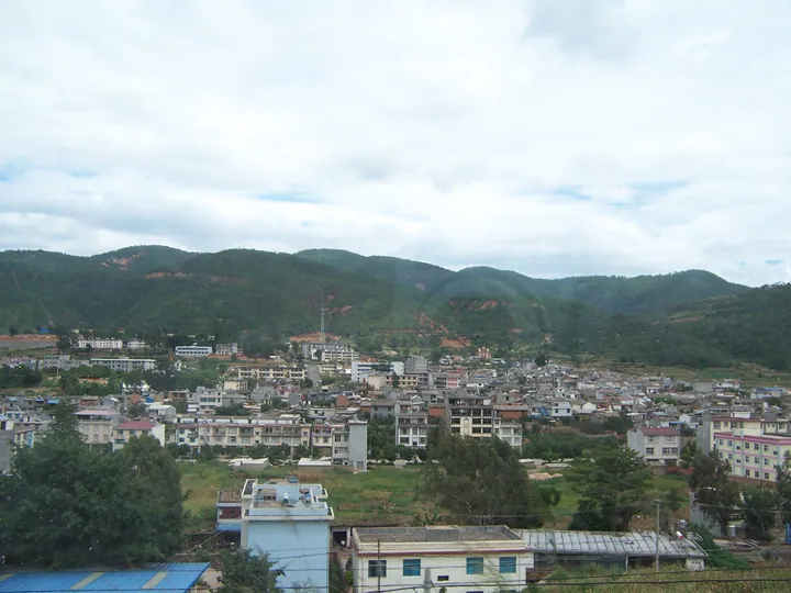 Small town surrounded by green hills in Xinping County