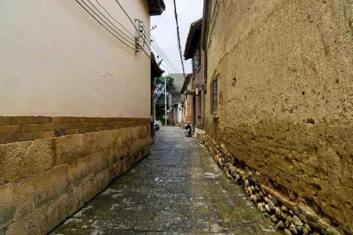 Narrow stone alley between traditional houses in Shiping ancient city
