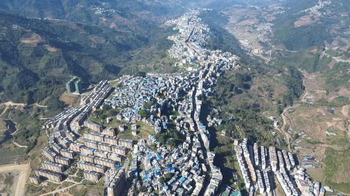 Aerial view of the hillside county seat of Lüchun County