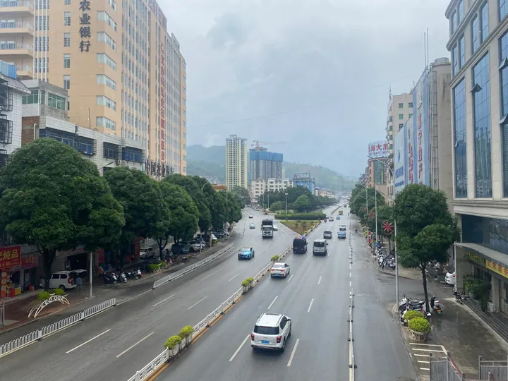 A wide city street lined with tall buildings in Funing County