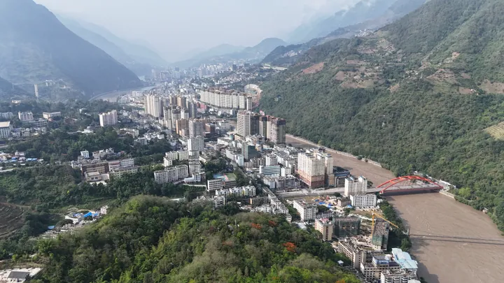 Aerial view of Liuku town squeezed into a mountain gorge along the Nujiang River