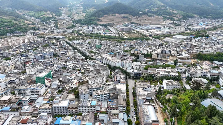 Aerial cityscape of Weixi surrounded by mountains