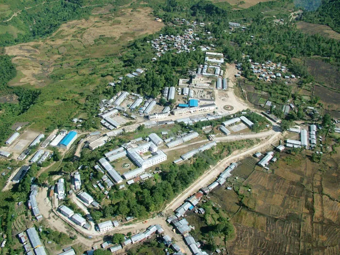 Aerial view of Mêdog town surrounded by forest and rice terraces