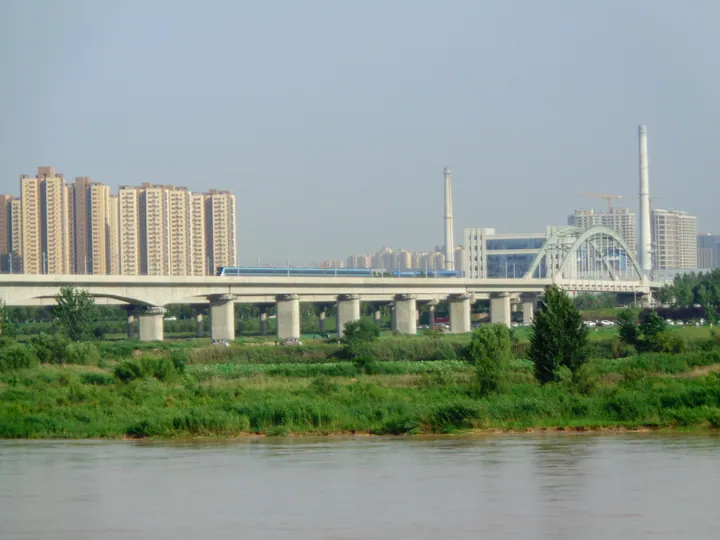 Railway bridge over the Wei River with city skyline, Weicheng District