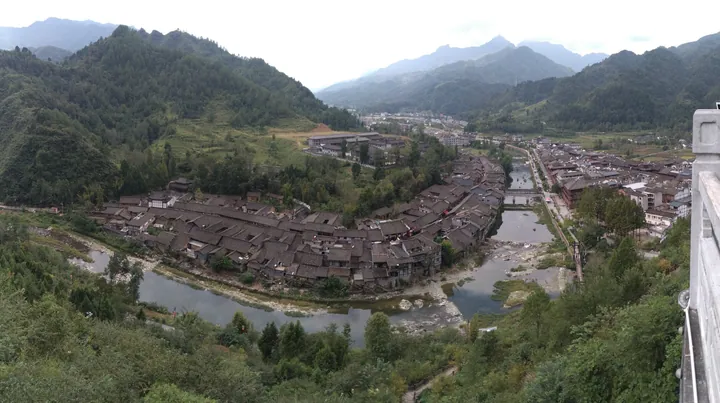 Elevated view of Ningqiang's riverside old town with traditional rooftops