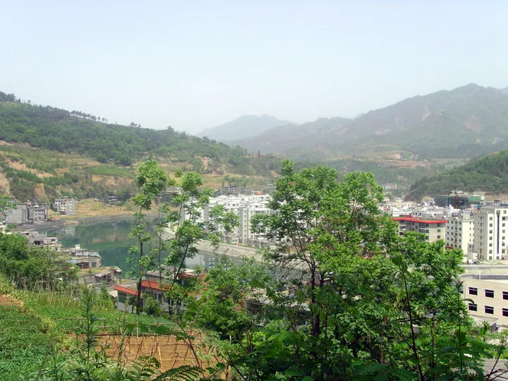 Elevated view of houses beside a river in Langao County town