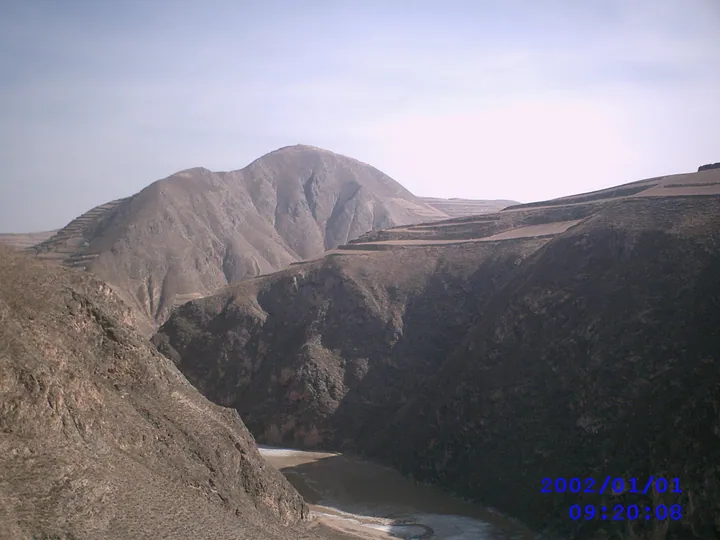 A deep canyon with a river below a mountain summit in Tongwei County