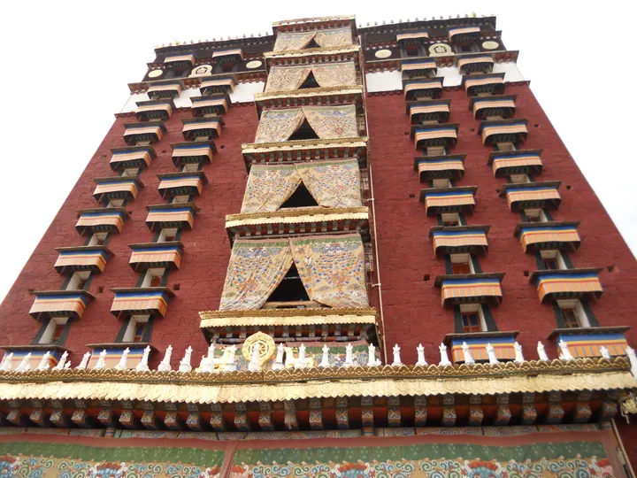 Ornate painted facade of the Milarepa Tower, a landmark temple in Hezuo
