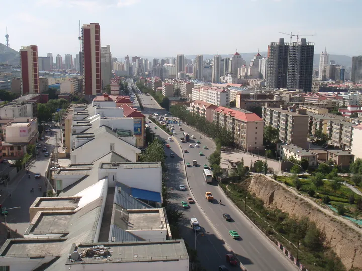 Elevated view of a city street with traffic and skyscrapers in Chengzhong District, Xining