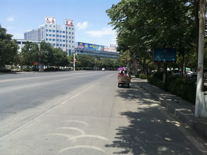 City street with shops and a shopping center in Hami