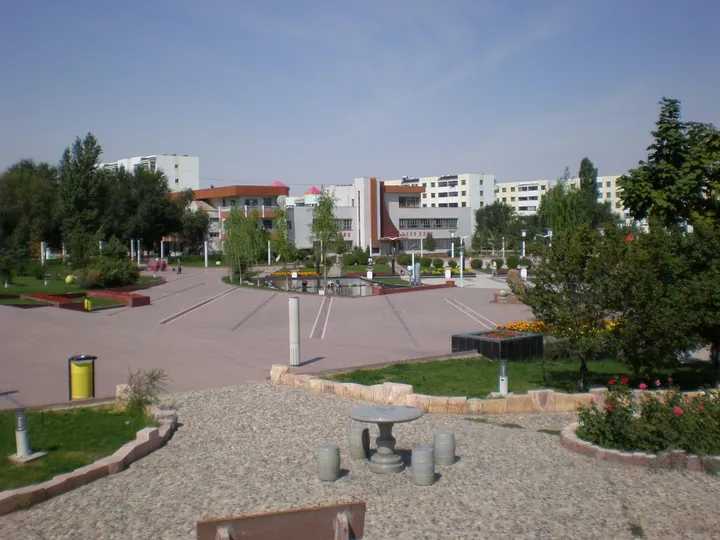 Landscaped public plaza with buildings in Fukang