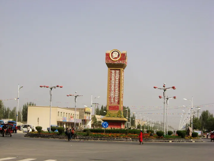 Monument at a road junction, downtown Minfeng