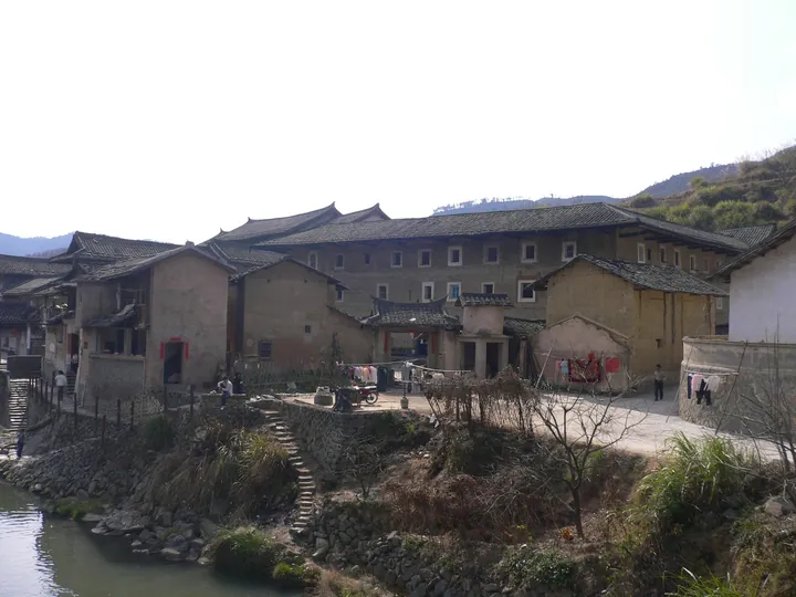 Traditional Hakka earthen tulou buildings beside a stream at Hongkeng, Yongding