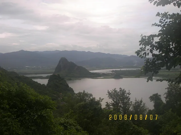 Limestone karst peak beside a lake near a cave attraction in Yingde