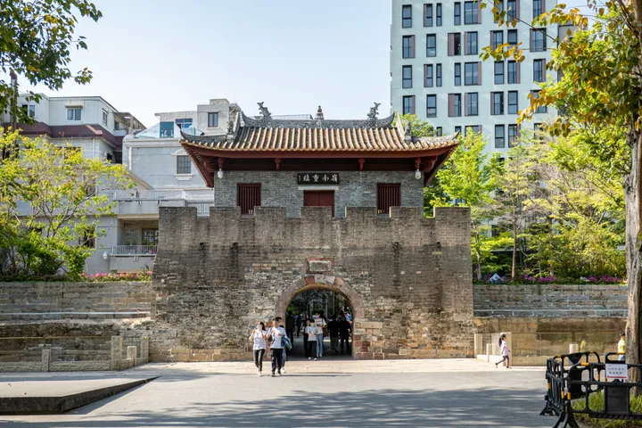 Stone city gate tower with a traditional tiled roof