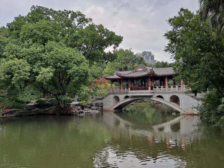 Arched pavilion bridge crossing a lake at Liuhou Park, Liuzhou