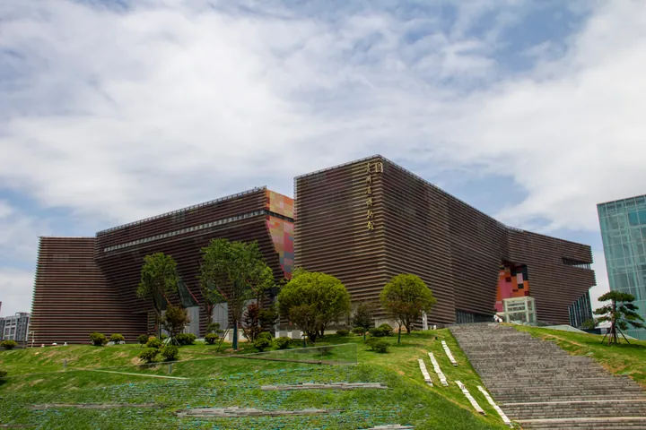 The wood-toned, angular exterior of Guizhou Provincial Museum with entrance stairs