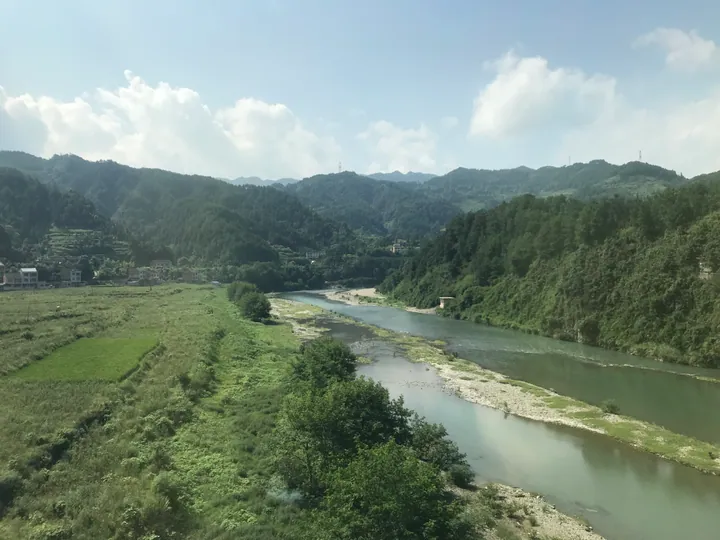 River winding through a green valley with terraced fields in Zhenyuan County