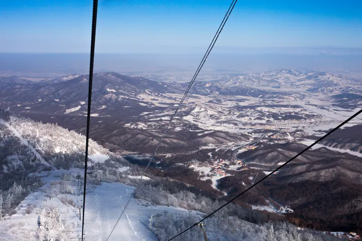 Snowy mountains and ski slopes viewed from a chairlift