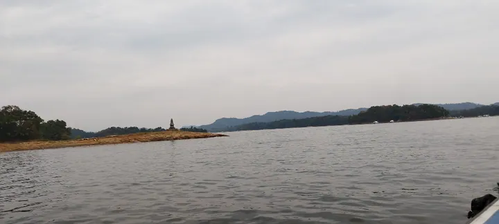 Calm reservoir waters with a small pagoda-topped island near Xinyang