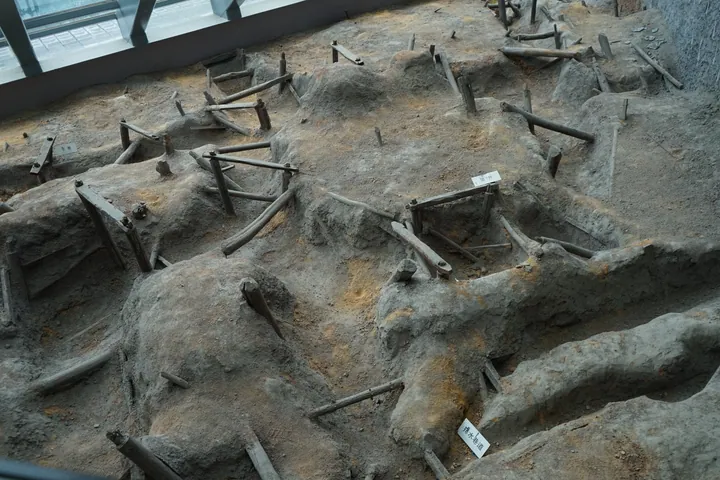 In-situ archaeological excavation of an ancient timber-lined mine shaft under a museum roof