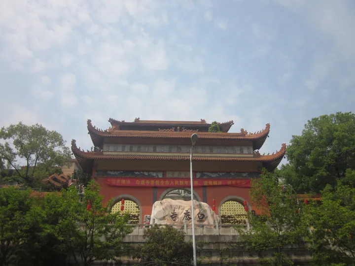 An ornate red and gold multi-tiered temple gate building