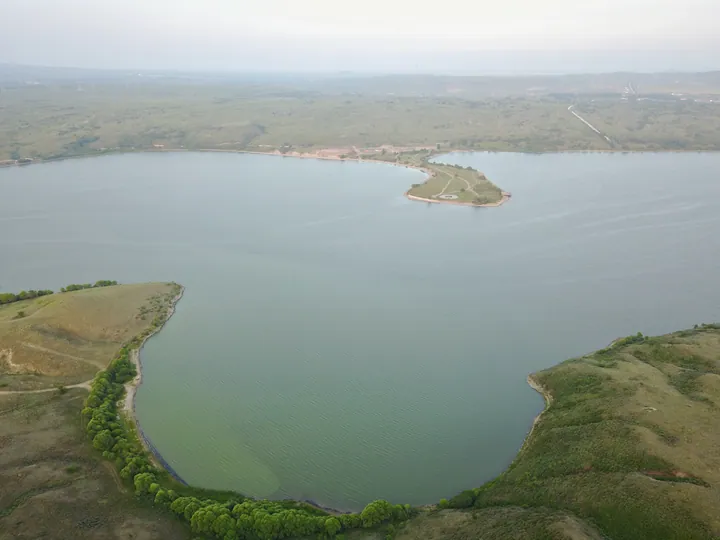 Aerial view of Duolun Lake with green shoreline and a peninsula