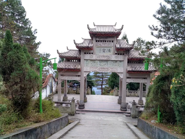 Ornate stone gateway with a mountain view beyond