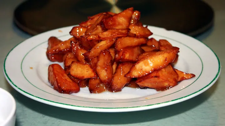 Plate of glossy caramelized sweet potato wedges