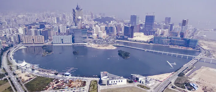 Aerial panorama of a lake surrounded by high-rise buildings