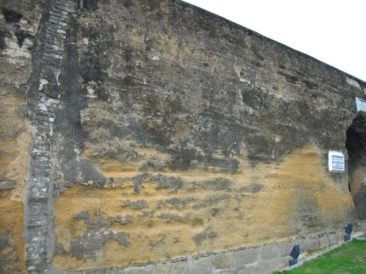 Weathered surface of the old rammed-earth city wall section in Macau