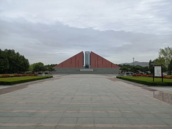 Angular red memorial building with a central spire at the Menglianggu Battle Memorial Hall