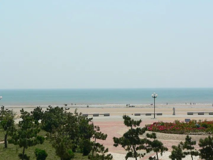 Beach and pine trees at the seaside plaza of Rizhao Seaside National Forest Park, Shandong