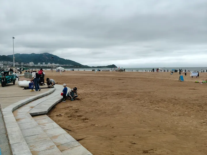 Sandy beach with visitors at Shi Lao Ren bathing beach, Qingdao