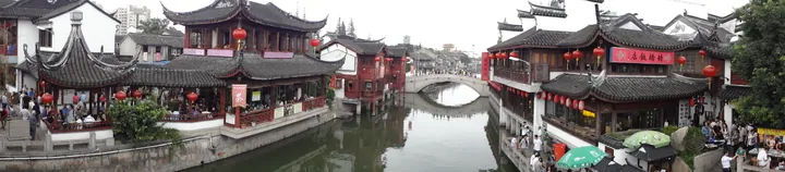 Panoramic view of traditional buildings with red lanterns along the canal at Qibao Old Street