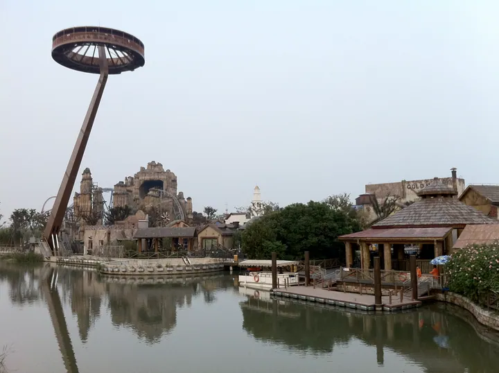Themed buildings and observation tower beside a lake at Shanghai Happy Valley, Songjiang District