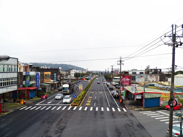 Elevated view of a township street lined with shops and traffic in Hukou Township