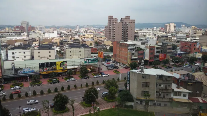 A dense cityscape of low- and mid-rise buildings under an overcast sky