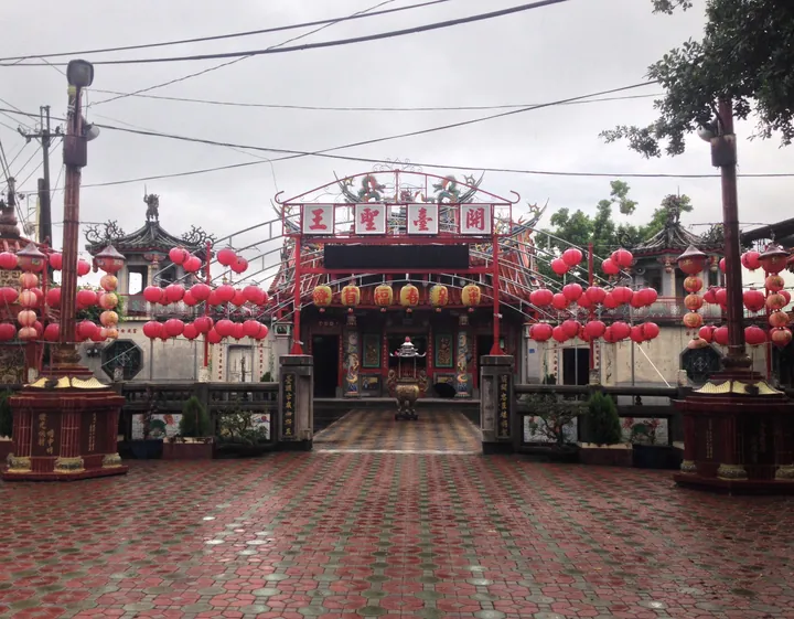 Ornate red temple gate with hanging lanterns in Linluo Township