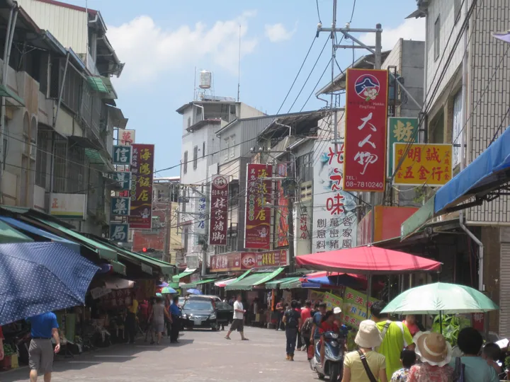 Bustling shopping street lined with shops and vendors in Wanluan Township