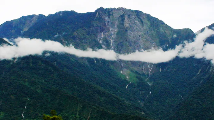 Steep forested cliff of North Dawu Mountain with clouds