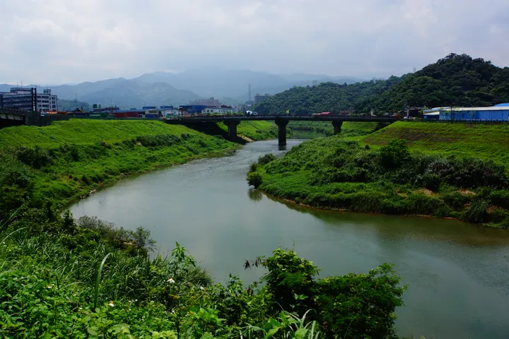 Bridge crossing a green river valley in Qidu District, Keelung