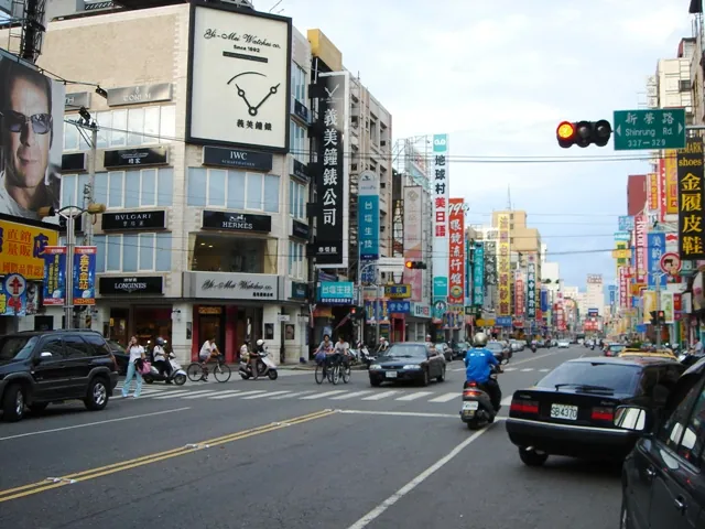 A city street lined with shops and traffic in the West District of Chiayi City