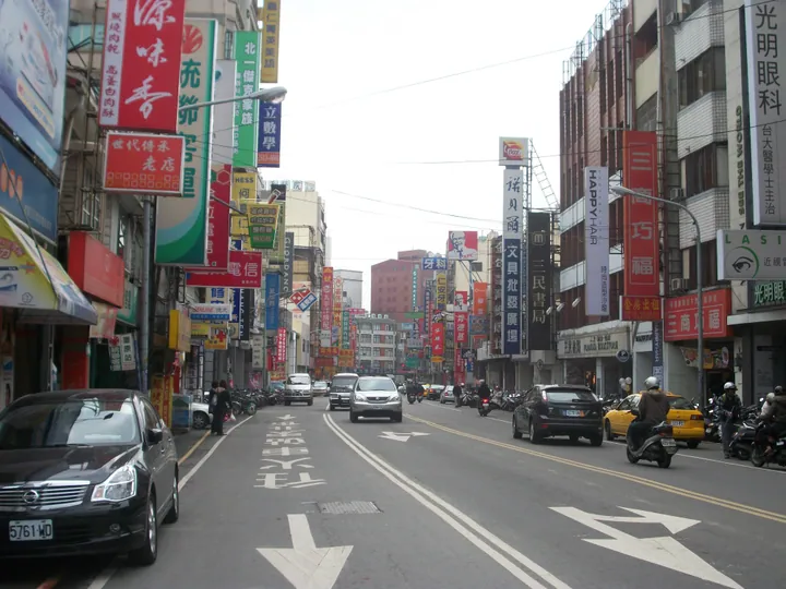 Busy shop-lined street in Fengyuan District with signage and traffic