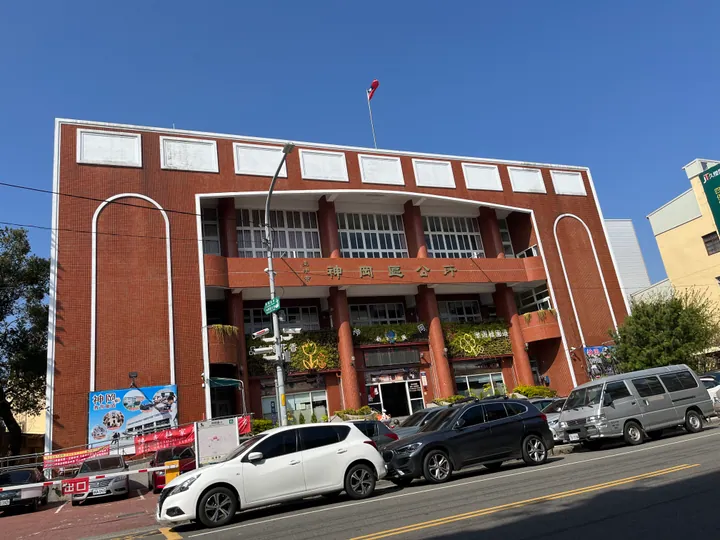 Red-brick multi-storey government office building with a flagpole in Shengang District, Taichung