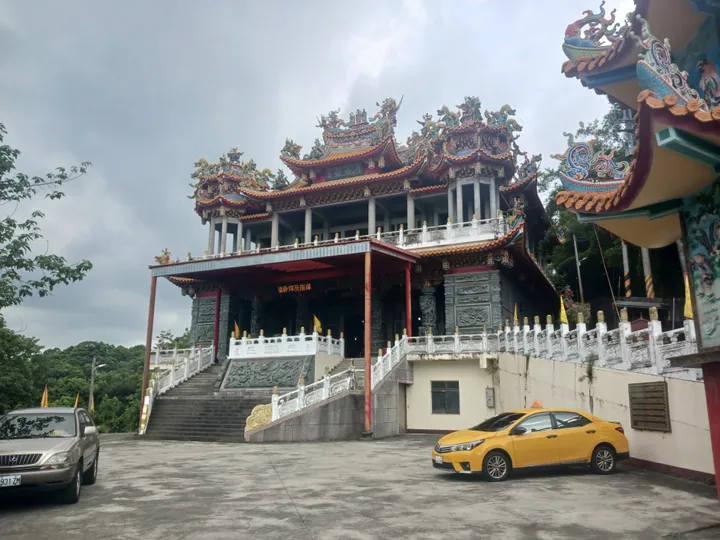 Ornate multi-tiered Chinese temple building with dragon roof decorations in Xinshe District, Taichung