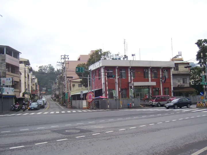 A small-town street corner with a red police station building in Shigang District, Taiwan