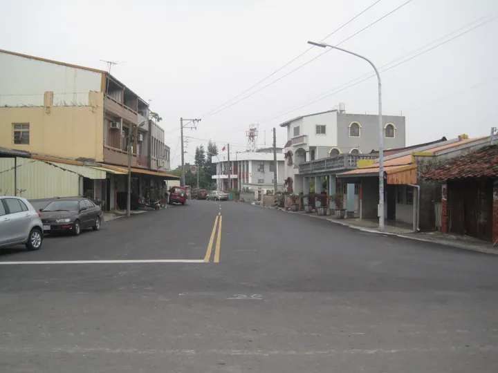 A small-town street lined with shophouses in Xiaying District, Tainan